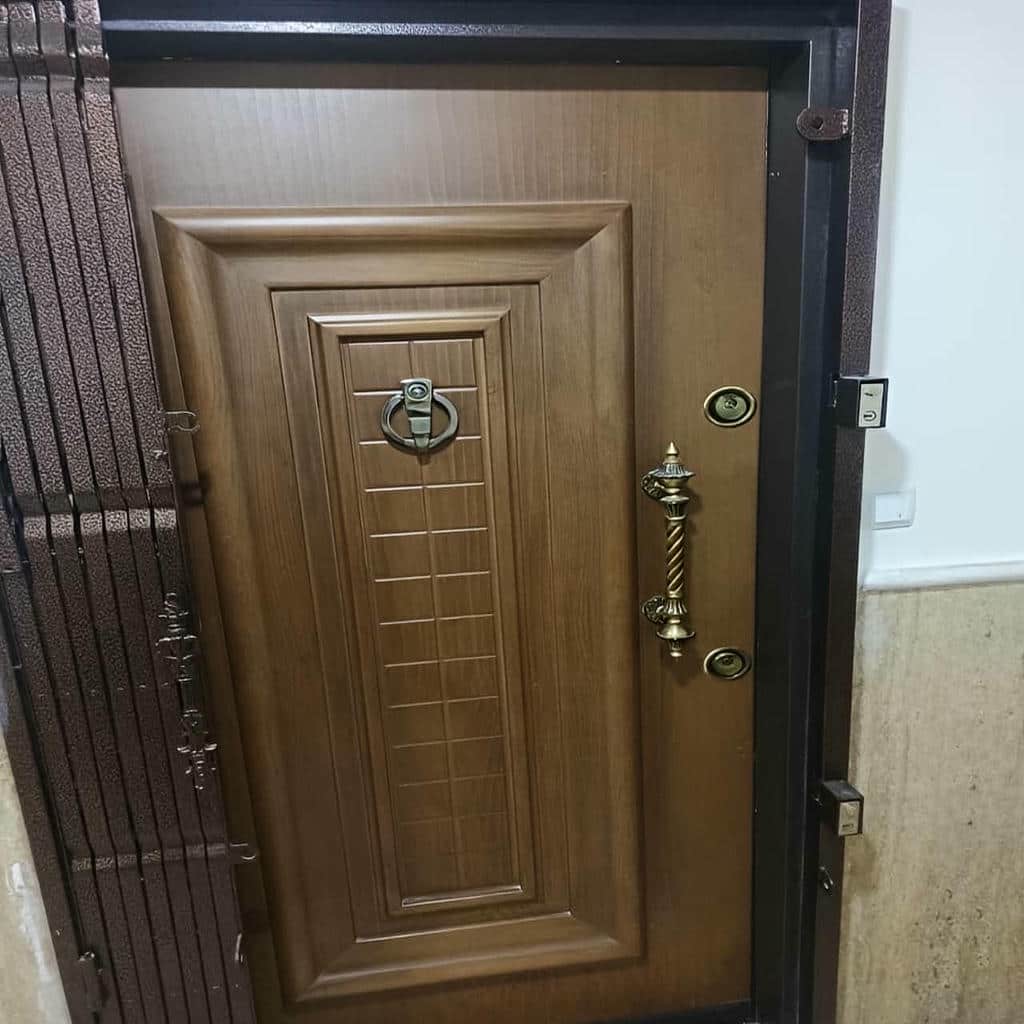 حفاظ درب آکاردئونی قهوه‌ای روی چارچوب کم‌عرض